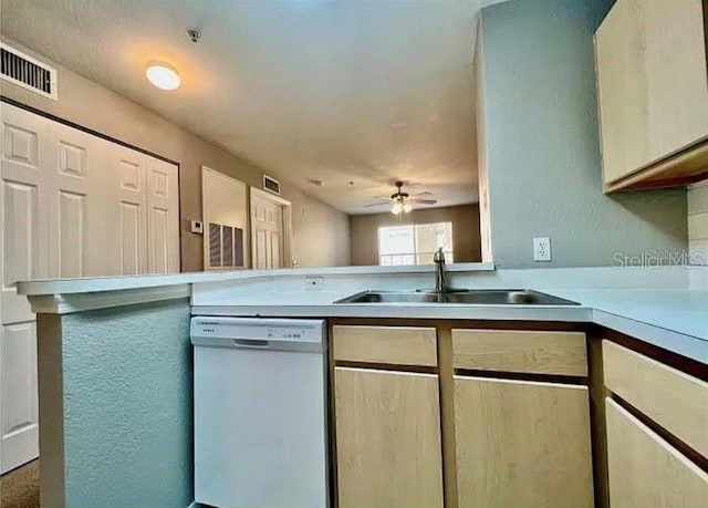 kitchen with kitchen peninsula, white dishwasher, ceiling fan, and sink