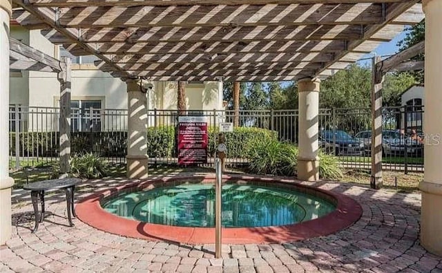 view of pool with a pergola and a hot tub