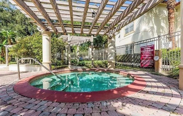 view of swimming pool with a community hot tub and a pergola