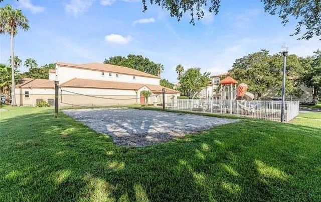 surrounding community featuring a playground and a lawn