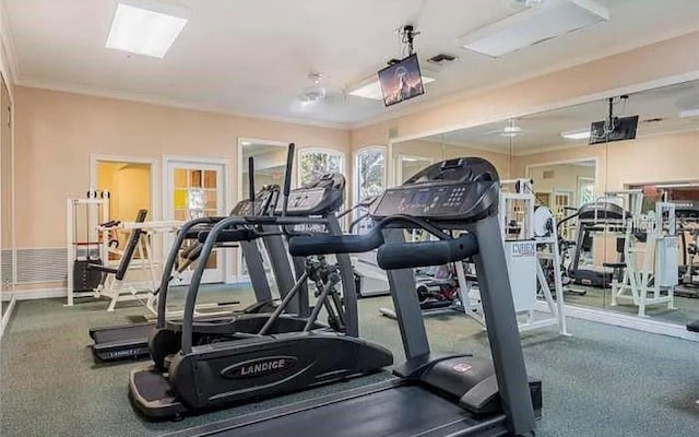 gym with crown molding and carpet floors