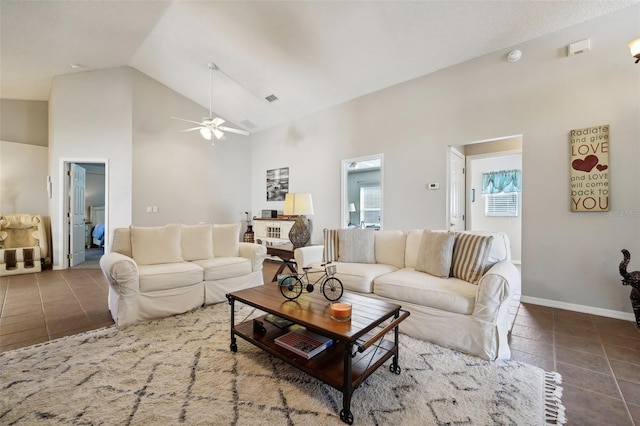 tiled living room featuring high vaulted ceiling and ceiling fan