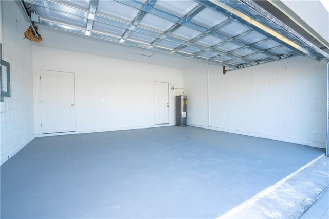 garage featuring electric panel and electric water heater