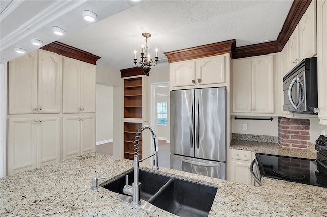 kitchen featuring sink, a chandelier, a textured ceiling, decorative light fixtures, and appliances with stainless steel finishes