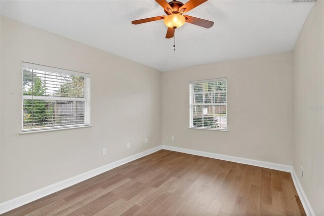 spare room with wood-type flooring and ceiling fan