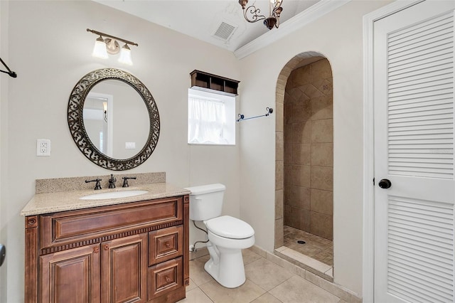 bathroom with vanity, tile patterned floors, crown molding, toilet, and a tile shower