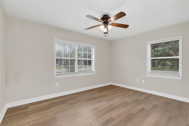 unfurnished room with ceiling fan and hardwood / wood-style floors