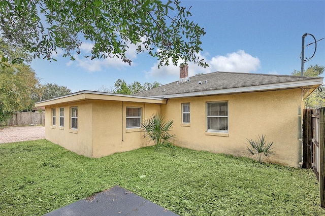 rear view of property featuring a yard