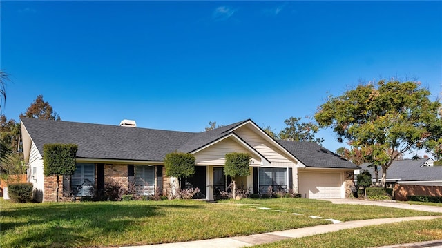 view of front of property with a front yard and a garage