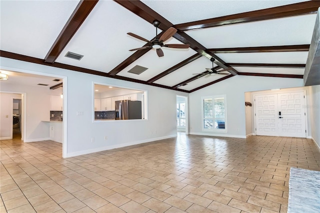 unfurnished living room with ceiling fan and lofted ceiling with beams