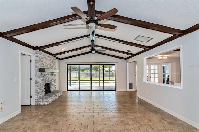 unfurnished living room featuring french doors, a brick fireplace, vaulted ceiling with beams, ceiling fan, and a textured ceiling