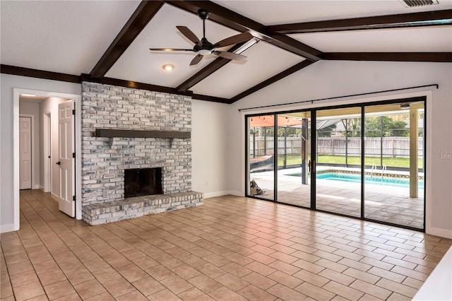 unfurnished living room with vaulted ceiling with beams, ceiling fan, and a brick fireplace