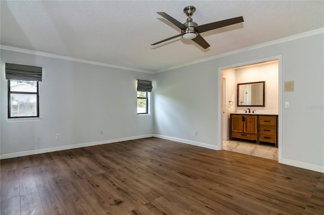 unfurnished bedroom with ceiling fan, dark hardwood / wood-style flooring, ensuite bath, and multiple windows