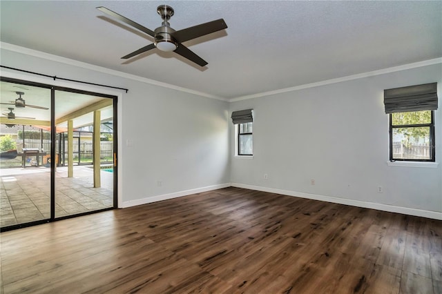 empty room with wood-type flooring, ornamental molding, ceiling fan, and a healthy amount of sunlight