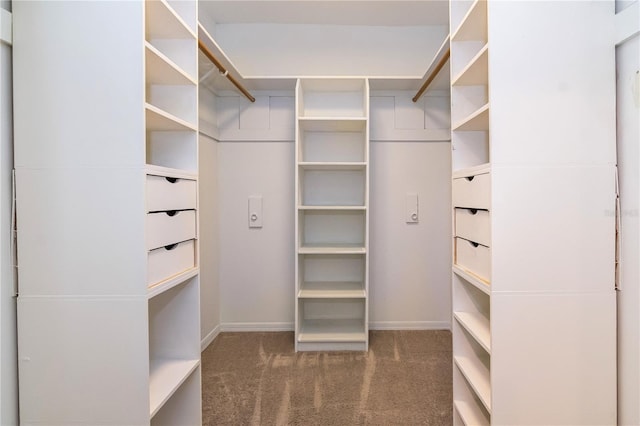 spacious closet featuring dark carpet