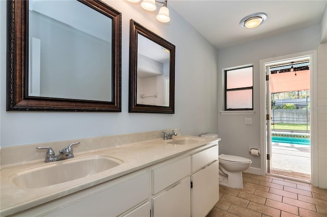 bathroom featuring tile patterned floors, vanity, and toilet