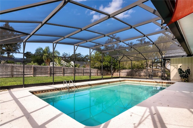 view of swimming pool with glass enclosure and a patio area