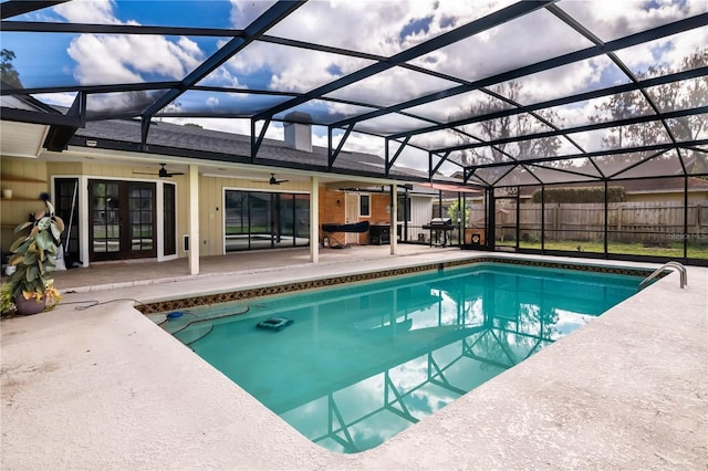 view of pool with french doors, ceiling fan, a lanai, area for grilling, and a patio