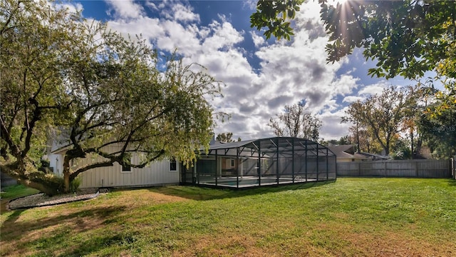 view of yard featuring a pool and glass enclosure