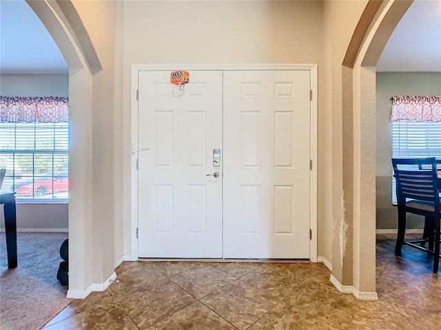 tiled foyer with a wealth of natural light