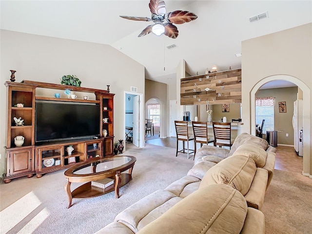 living room featuring light colored carpet, high vaulted ceiling, and ceiling fan