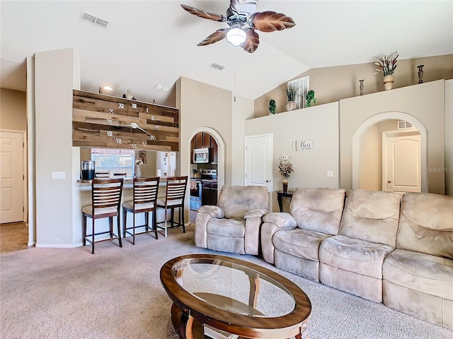 living room with light colored carpet, high vaulted ceiling, and ceiling fan