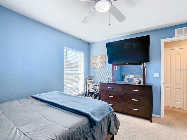 bedroom with ceiling fan and light colored carpet