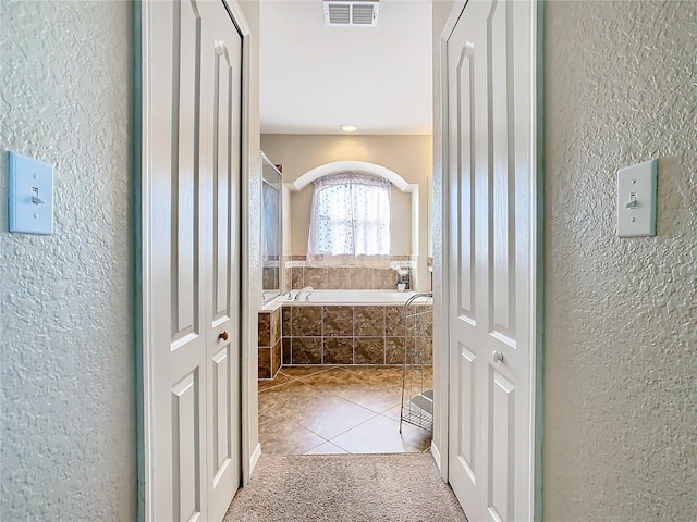 corridor featuring light tile patterned flooring