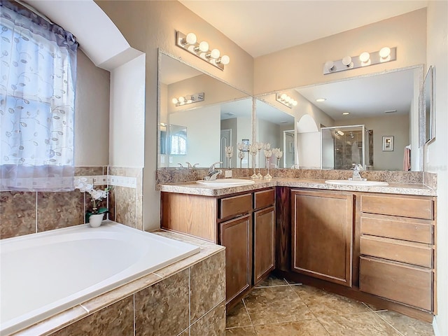 bathroom with tile patterned floors, vanity, and plus walk in shower