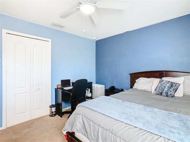 bedroom featuring ceiling fan, light colored carpet, and a closet