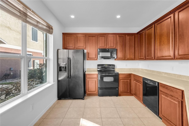 kitchen featuring light tile patterned flooring and black appliances