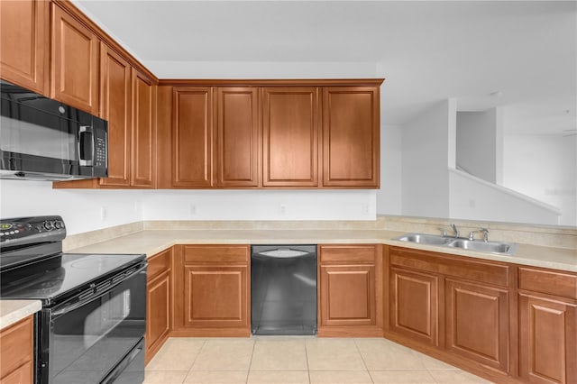 kitchen featuring sink, light tile patterned flooring, and black appliances