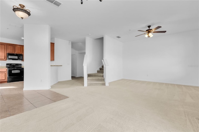 unfurnished living room featuring ceiling fan and light colored carpet