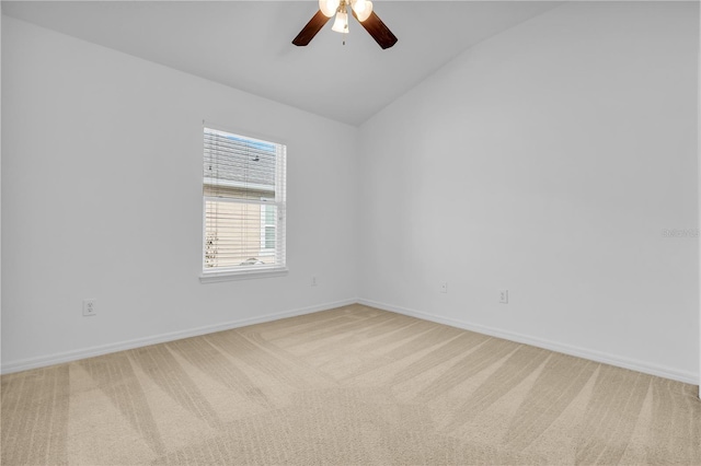 carpeted empty room featuring ceiling fan and vaulted ceiling