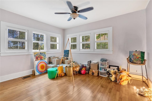 recreation room with light hardwood / wood-style flooring, a wealth of natural light, and ceiling fan