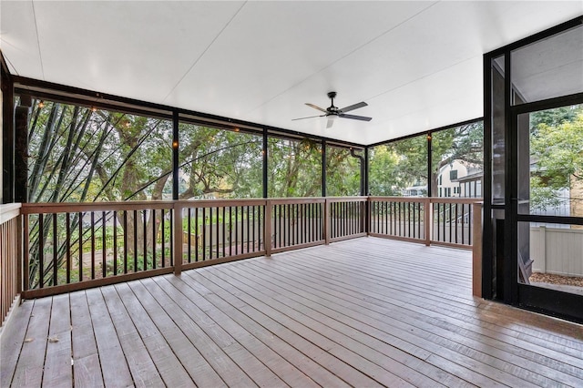 unfurnished sunroom featuring ceiling fan