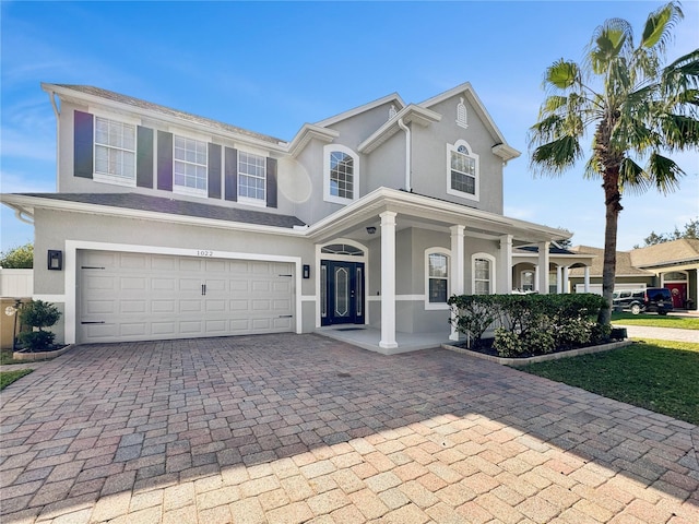 view of front of property with a porch and a garage