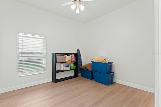 recreation room with ceiling fan and light wood-type flooring