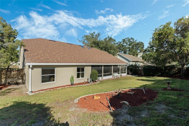 back of house with a lawn and a sunroom