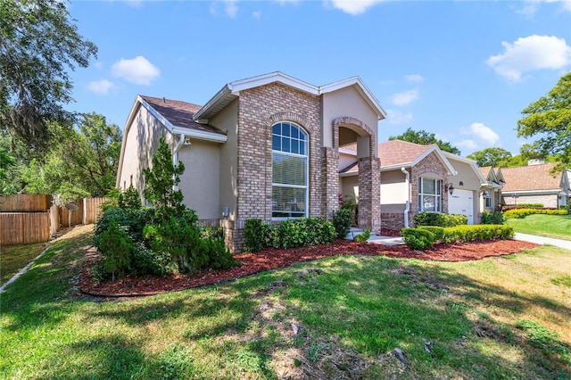 2226 Lake Marion Dr, Apopka, FL 32712 - view of front of property with fence, an attached garage, a front lawn, and stucco siding