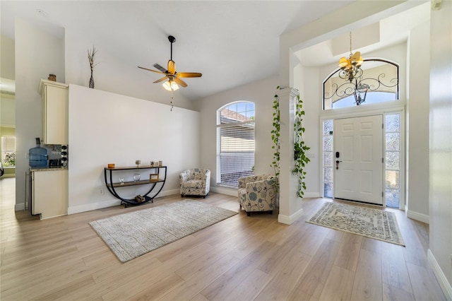 2226 Lake Marion Dr, Apopka, FL 32712 - entrance foyer featuring high vaulted ceiling, baseboards, ceiling fan with notable chandelier, and light wood-style floors