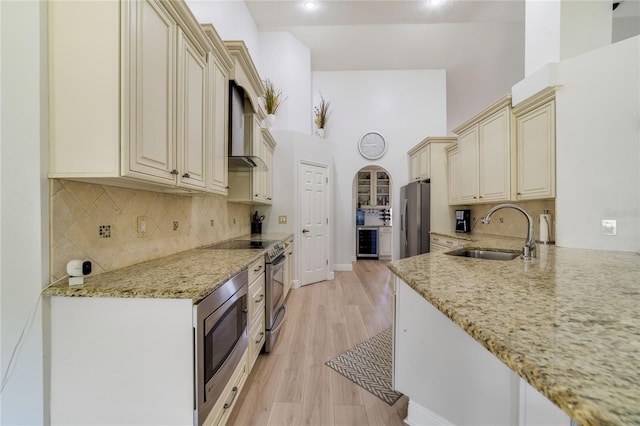 2226 Lake Marion Dr, Apopka, FL 32712 - kitchen with appliances with stainless steel finishes, a sink, light stone counters, wine cooler, and cream cabinetry