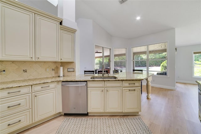 2226 Lake Marion Dr, Apopka, FL 32712 - kitchen featuring light wood-style floors, decorative backsplash, cream cabinets, and stainless steel dishwasher