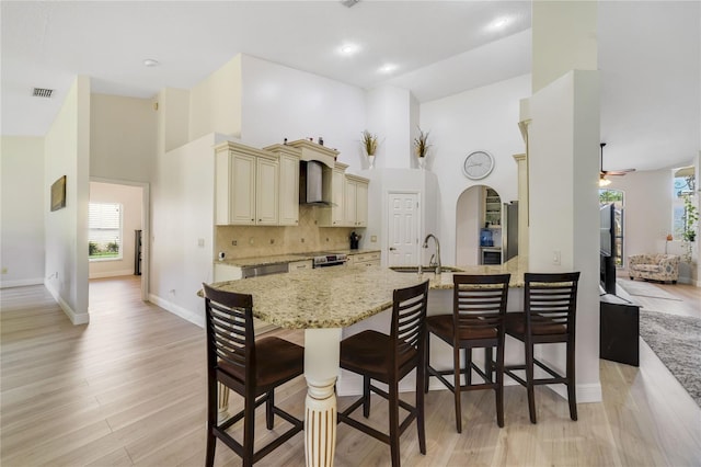 2226 Lake Marion Dr, Apopka, FL 32712 - kitchen with a sink, cream cabinetry, visible vents, and a towering ceiling
