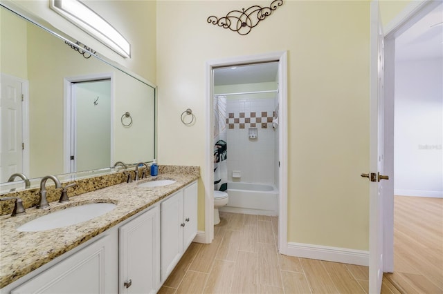 2226 Lake Marion Dr, Apopka, FL 32712 - full bathroom with double vanity, toilet, baseboards, and a sink