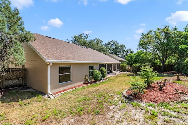 2226 Lake Marion Dr, Apopka, FL 32712 - back of house featuring a sunroom, a fenced backyard, stucco siding, and a shingled roof