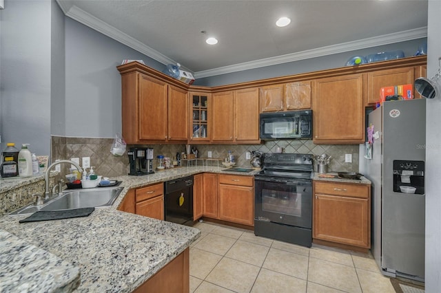 kitchen with light stone countertops, ornamental molding, sink, black appliances, and light tile patterned floors