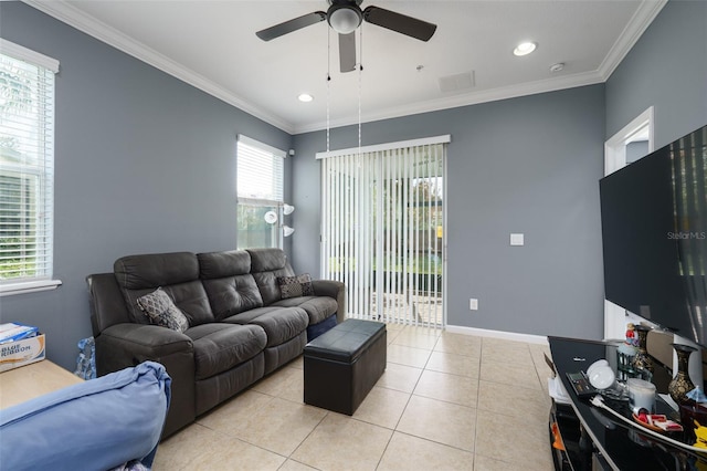 living room featuring a wealth of natural light, light tile patterned flooring, and ornamental molding