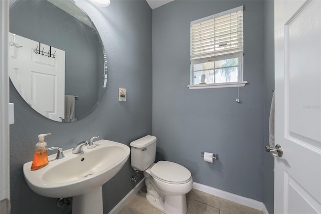 bathroom with tile patterned floors, toilet, and sink