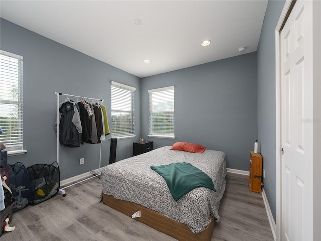 bedroom featuring light wood-type flooring and a closet